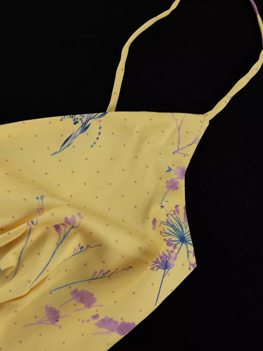 Yellow floral print slip dress with thin straps and a polka dot pattern.
