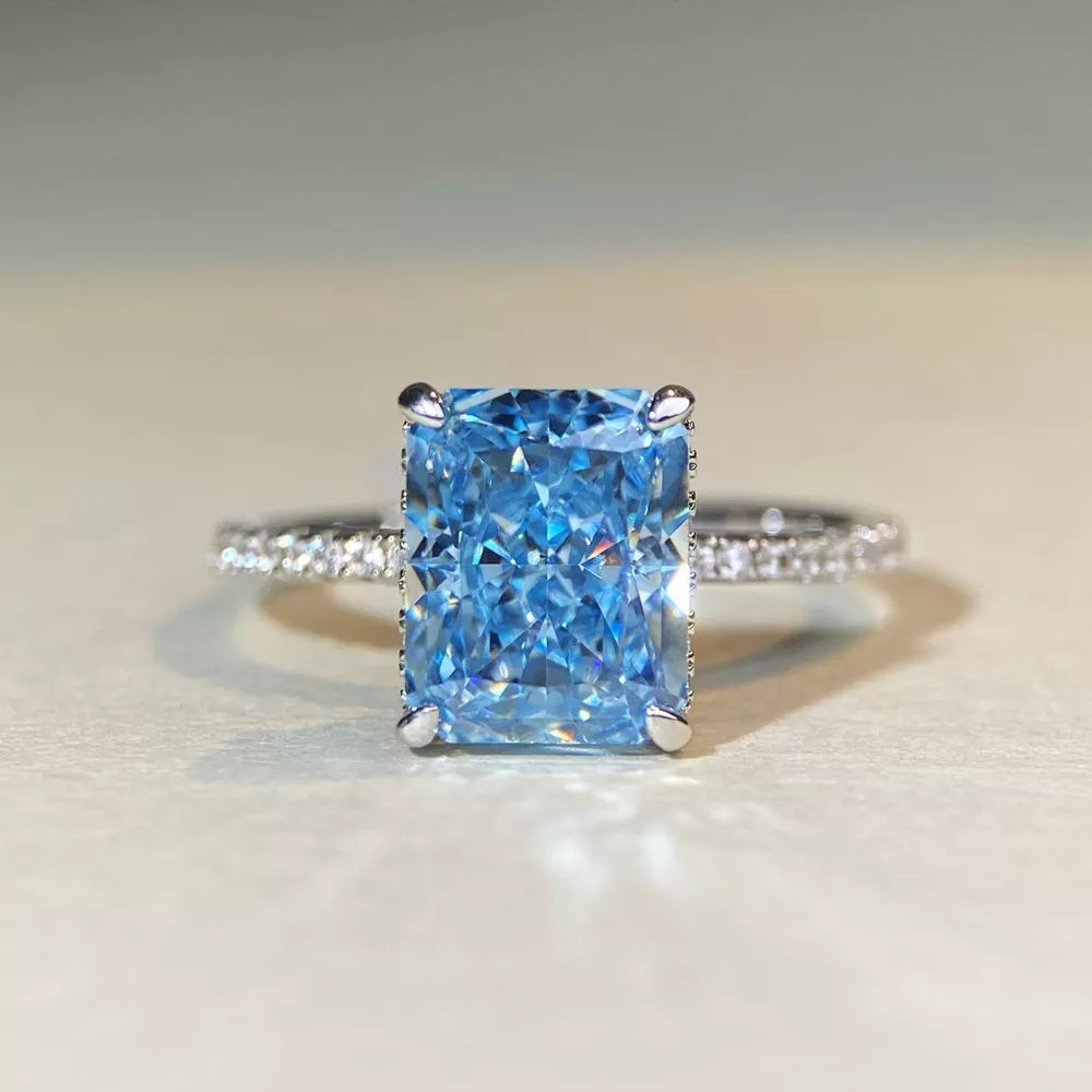 silver ring featuring rectangular cut gemstone and geometric
