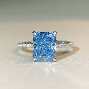 silver ring featuring rectangular cut gemstone and geometric