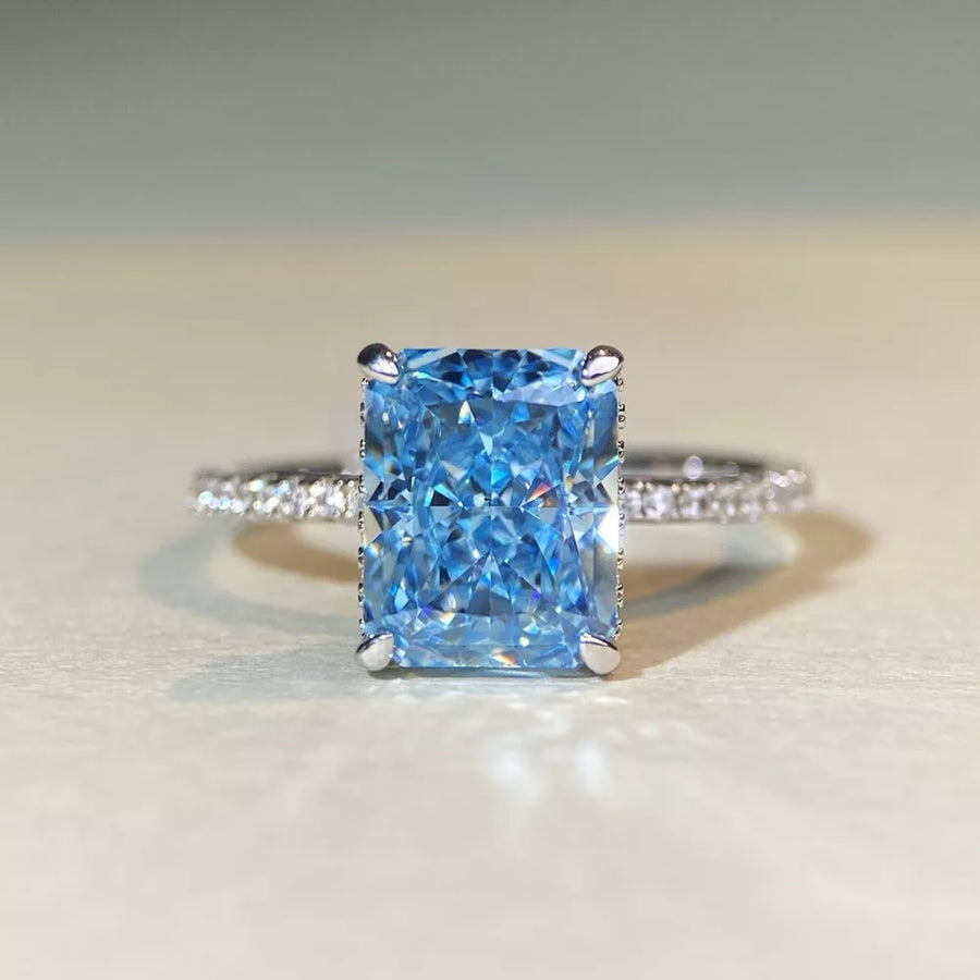 silver ring featuring rectangular cut gemstone and geometric