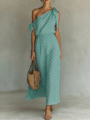 Teal polka dot one-shoulder maxi dress with tie details and elastic waist.