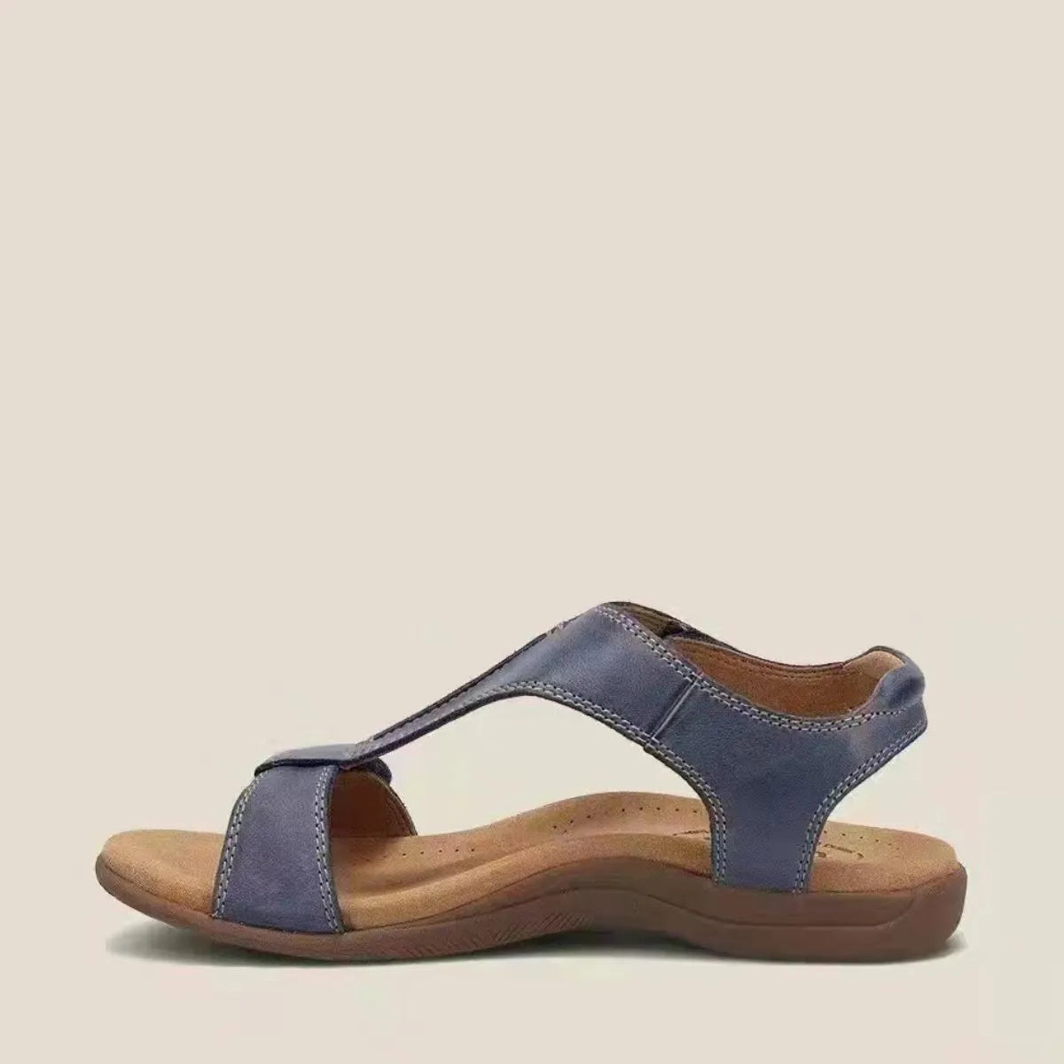 Navy leather T-strap comfort sandals with a contoured footbed and adjustable ankle strap.