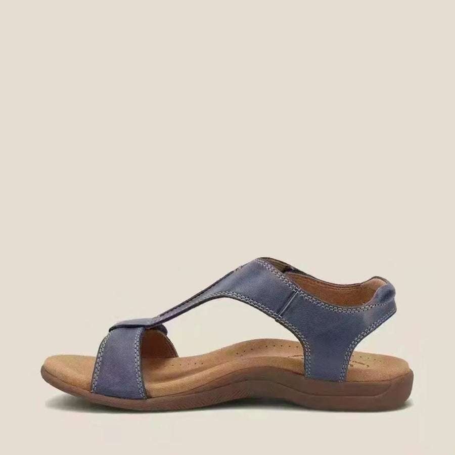 Navy leather T-strap comfort sandals with a contoured footbed and adjustable ankle strap.