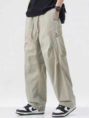 Loose fit khaki cargo pants with drawstring waist and multiple pockets.