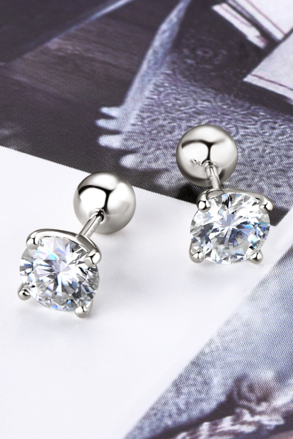 Sterling silver solitaire stud earrings with round cut moissanite stones.