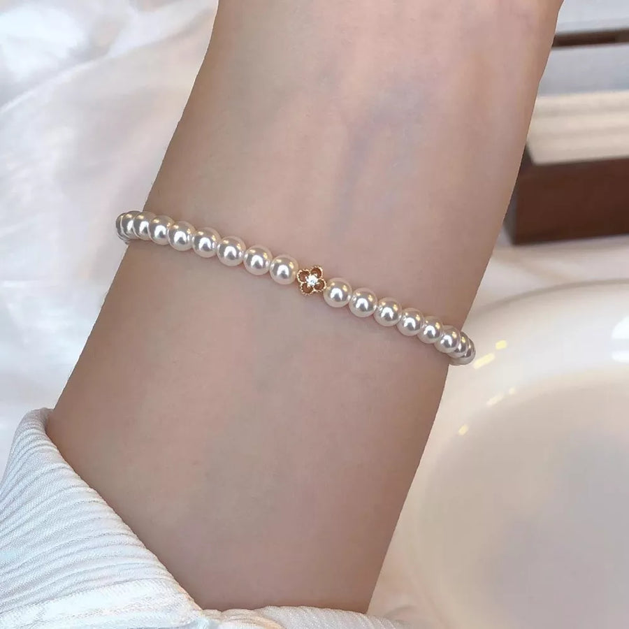 Synthetic Pearl, 18K Gold-Plated, Alloy, Zircon Care instructions: Avoid wearing bracelet in ivory with fitted silhouette