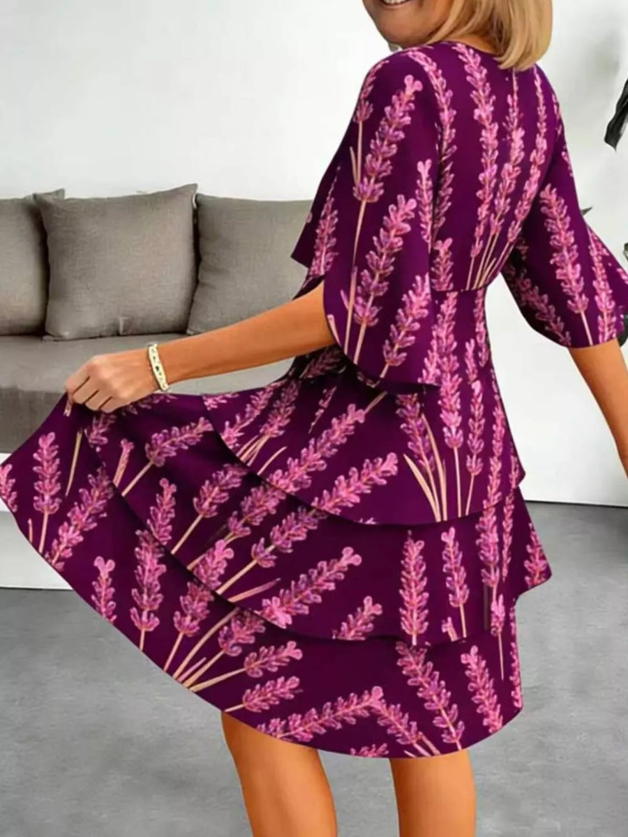 Purple floral tiered ruffle hem dress with flutter sleeves.