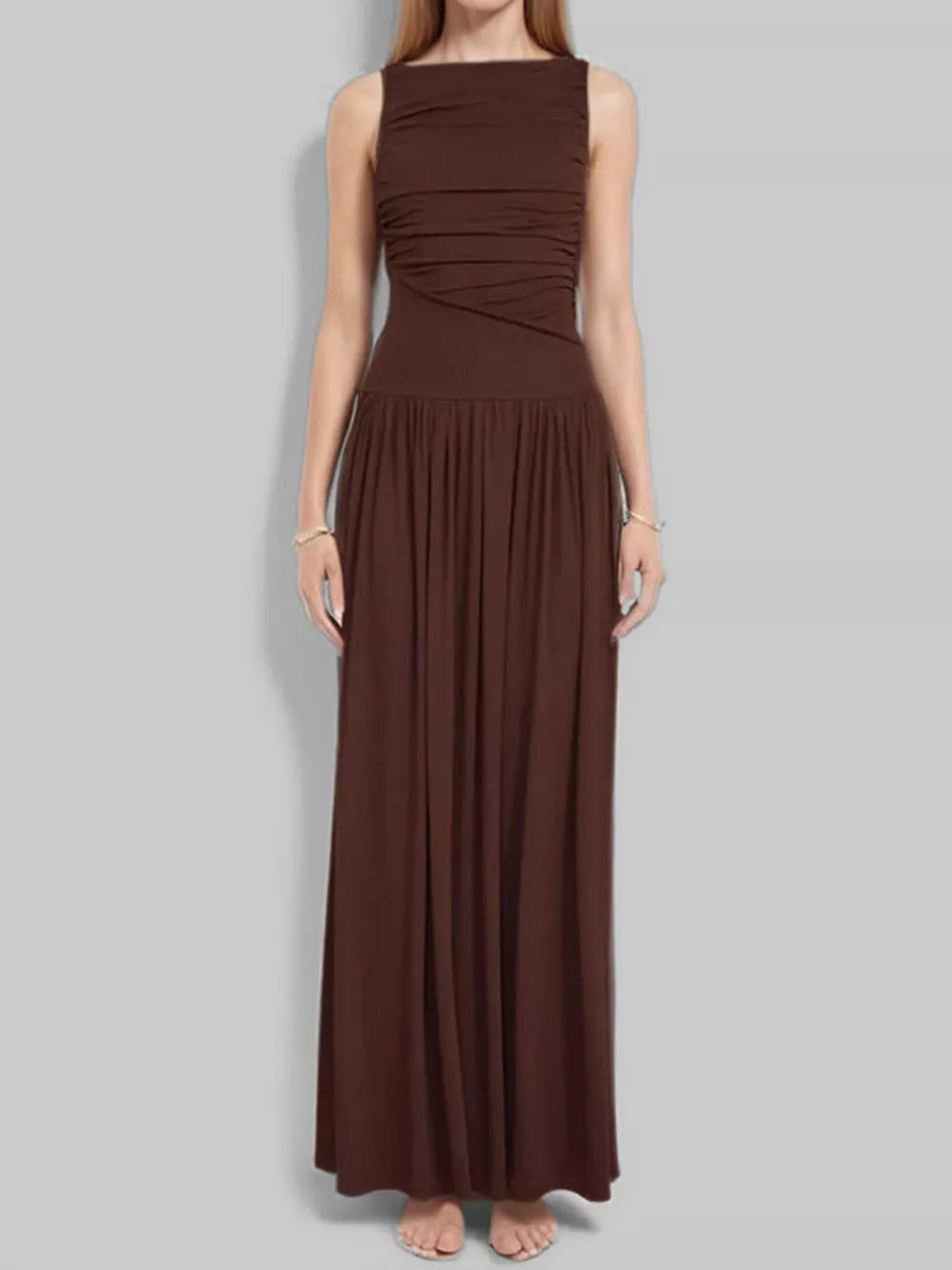 Brown ruched maxi dress with gathered neckline and flowing skirt.