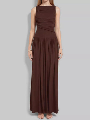 Brown ruched maxi dress with gathered neckline and flowing skirt.