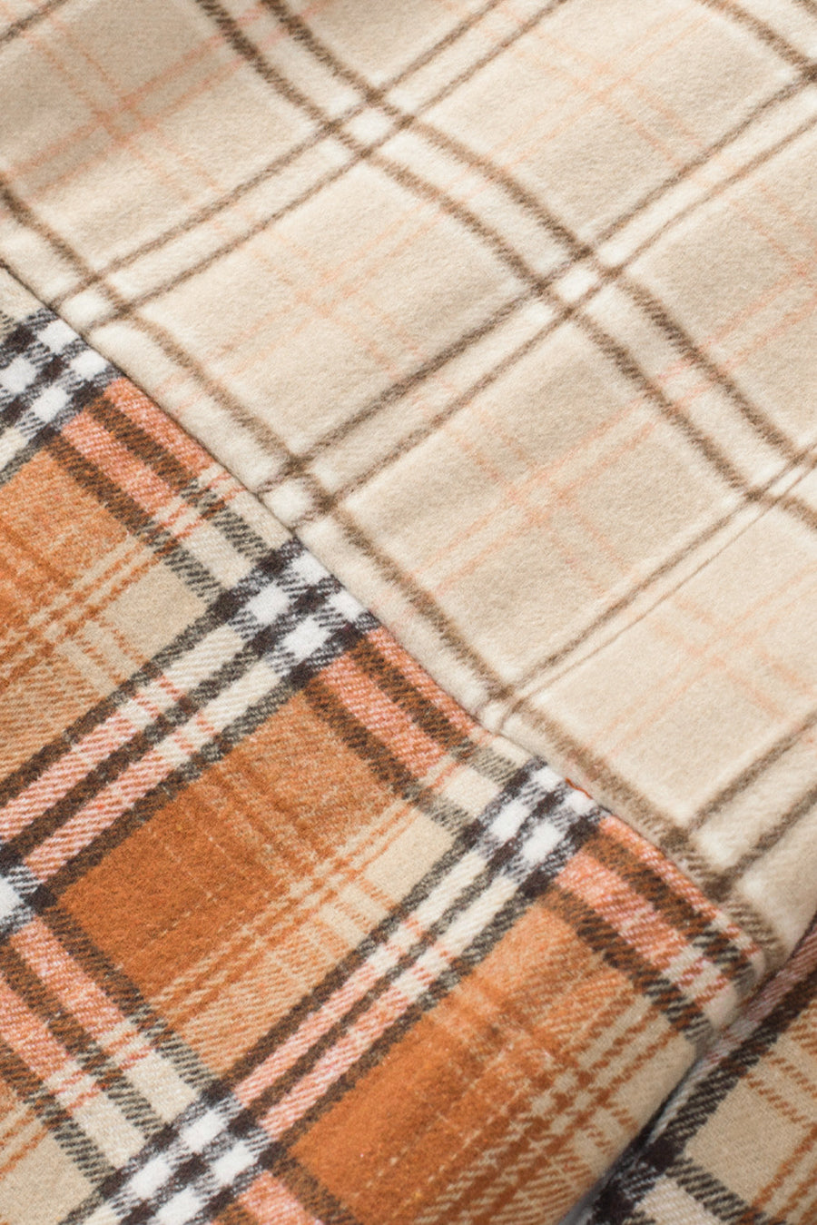 Patchwork plaid knit shacket in sherbet with contrasting plaid panels.