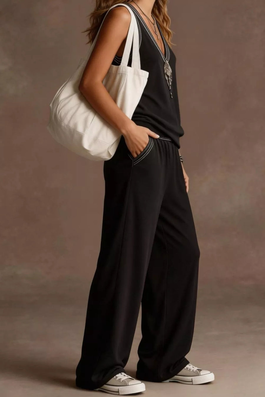 Black V-neck tank and wide-leg pants set with white contrast stitching and elastic waist.