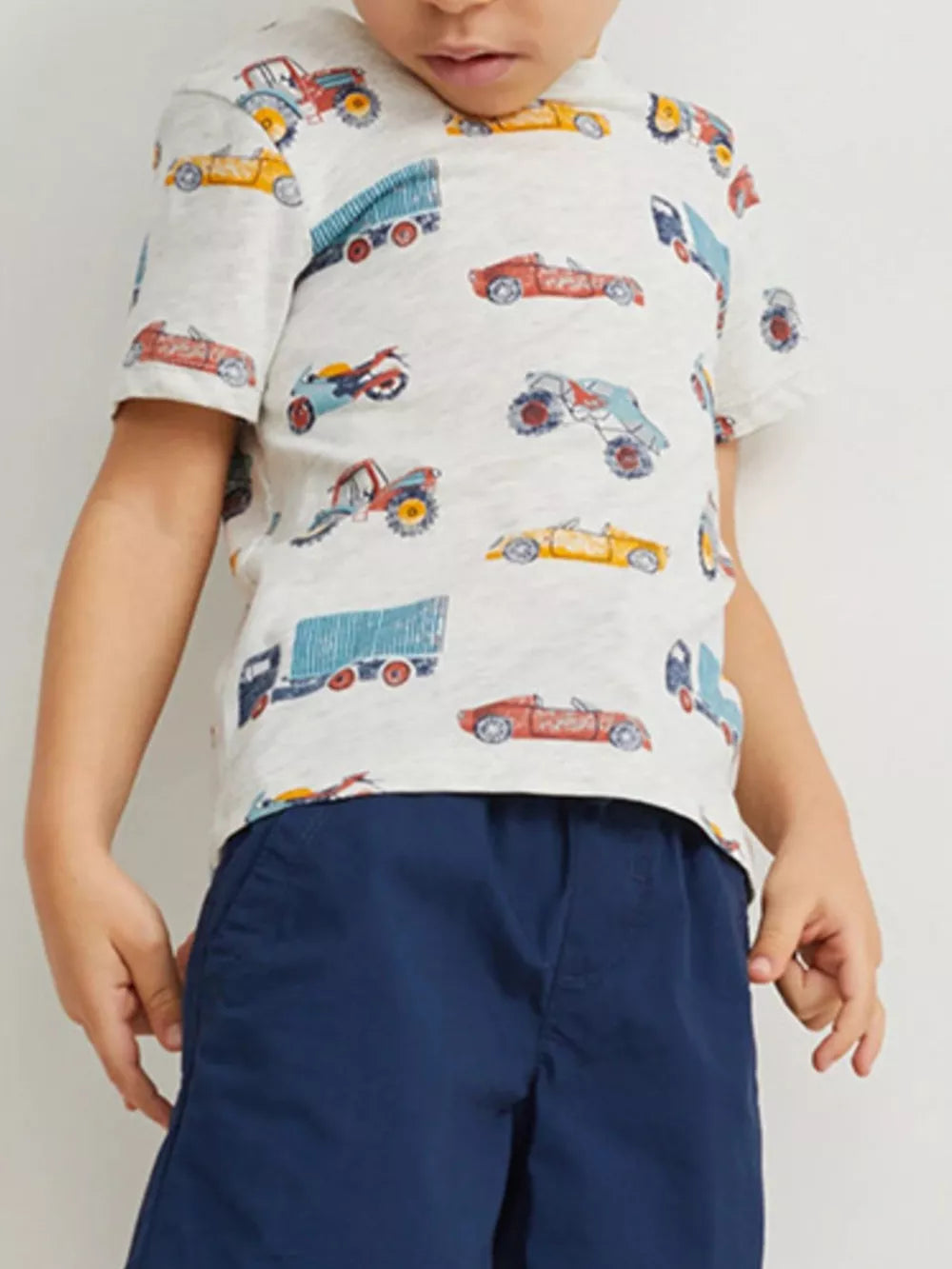 Toddler t-shirt in light grey with a playful all-over vehicle print, short sleeves, and crew neck.