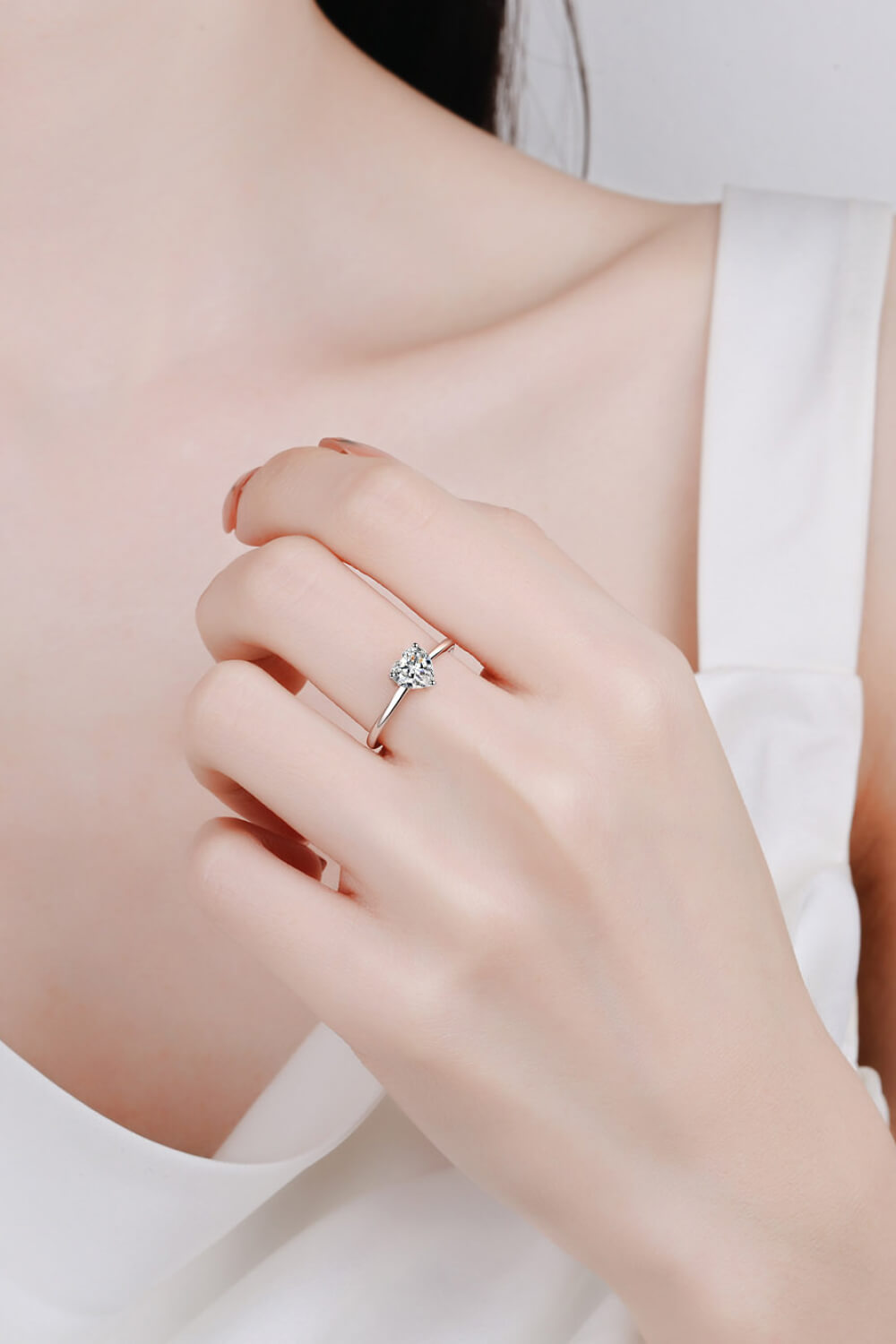 Silver ring with a heart-cut moissanite solitaire on a 925 sterling silver band.