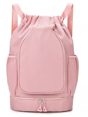 Blush pink drawstring duffel bag with zippered bottom compartment and side pockets.