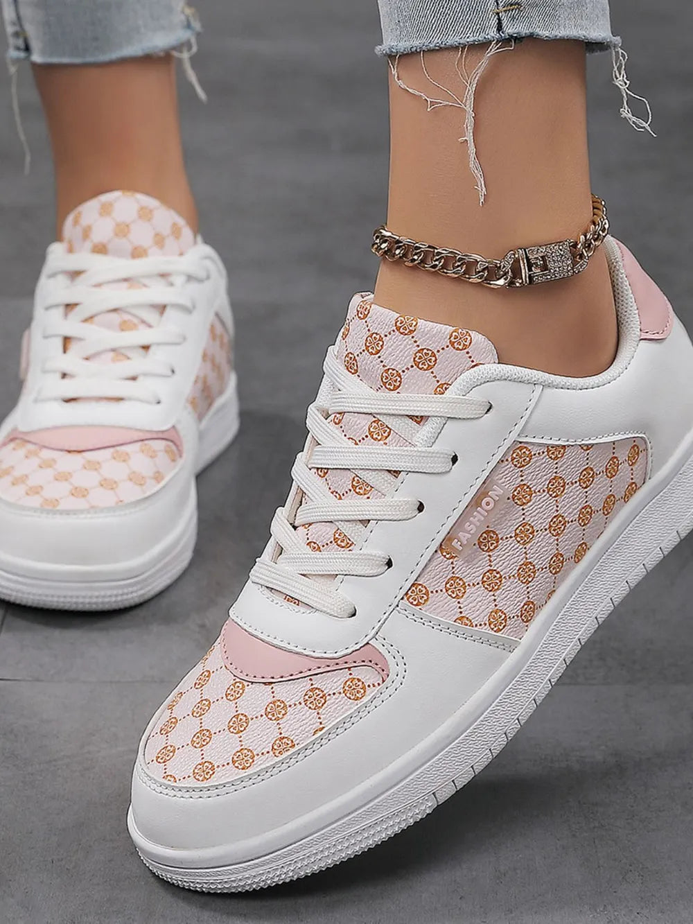 White and pink canvas court sneakers with a repeating geometric pattern and white laces.