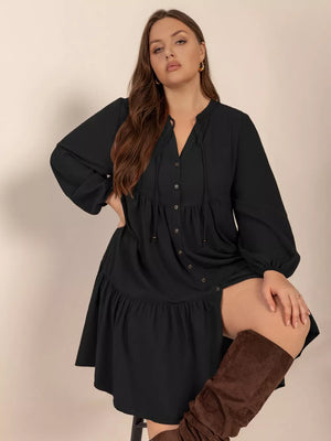 Plus-size black balloon sleeve dress with button front and tiered skirt
