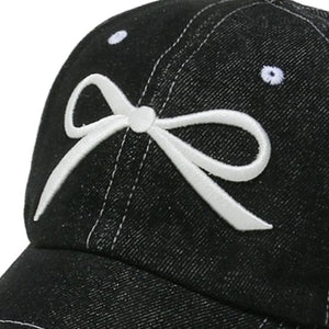 Black denim baseball cap with white embroidered bow detail