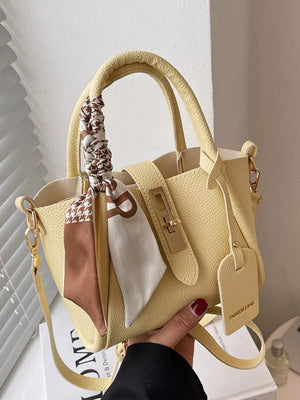 Yellow pebbled leather crossbody bag with scarf detail and gold hardware