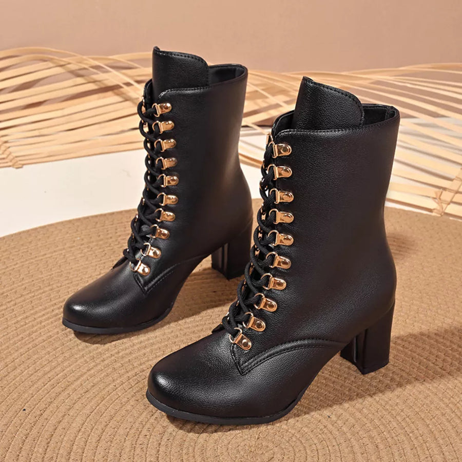 Black lace-up block heel boots with gold eyelets and laces.