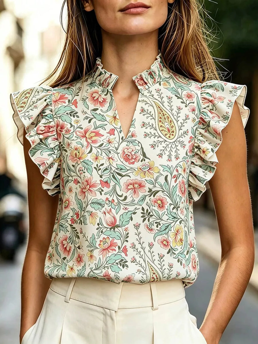 Cream floral print ruffled sleeve shirt with mock neck and keyhole detail.