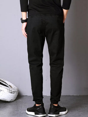 Black cotton twill jogger pants with elastic cuffs and a relaxed fit.