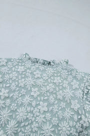Embroidered floral puff sleeve shirt with ruffled neckline in light blue polyester.