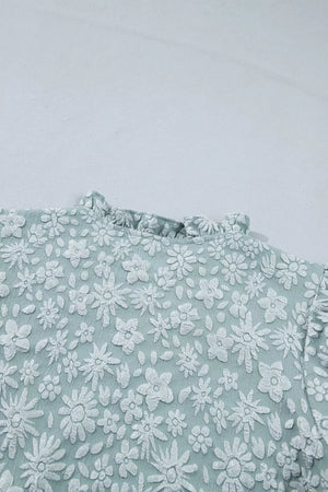 Embroidered floral puff sleeve shirt with ruffled neckline in light blue polyester.