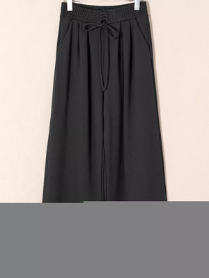 Black cotton maternity pants with drawstring high waist and pleats