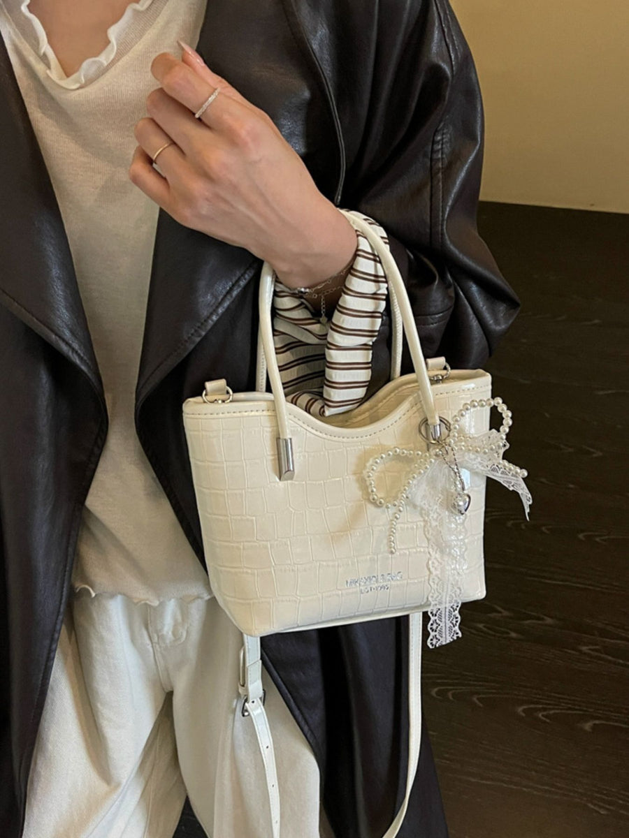 crossbody bag in black with top handle and small
