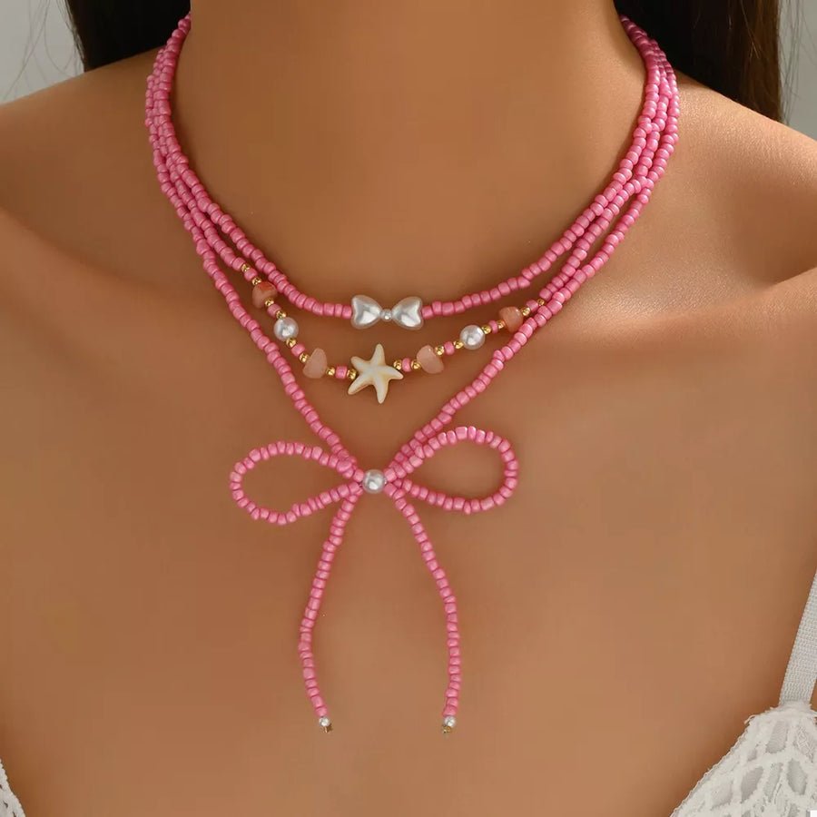 18K Gold-Plated, Alloy, Resin, Millet Pearl Care instructions: Avoid wearing dur necklace in Fuchsia Pink with layered