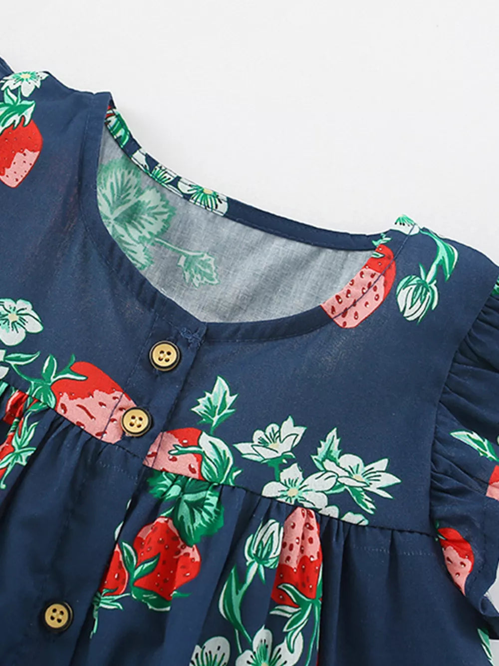 Navy blue cotton dress with strawberry print, ruffle sleeves, and button front.