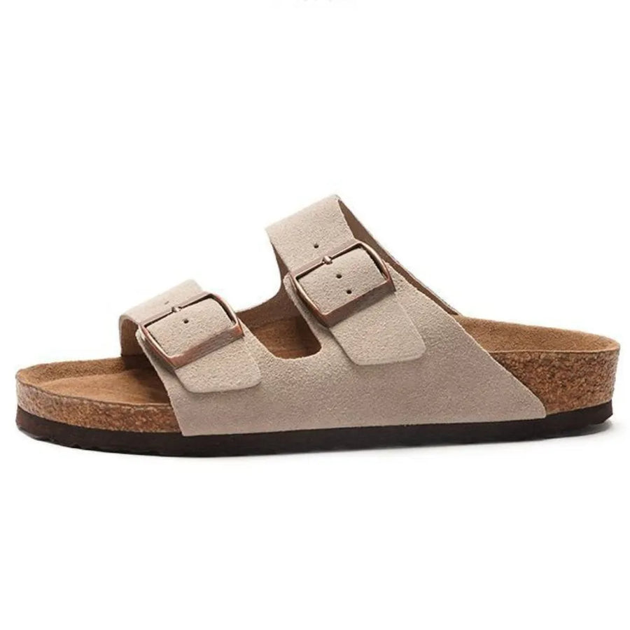 Suede slide sandals in beige with adjustable buckle straps and cork footbed.