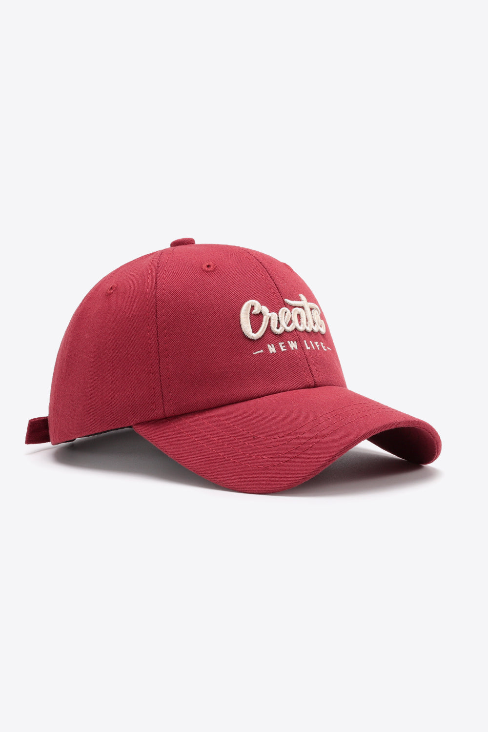 Deep Red baseball cap with embroidered "Create New Life" text, adjustable strap.