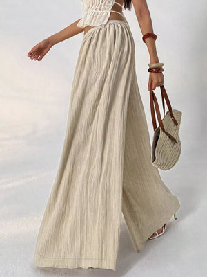 Textured wide-leg maternity pants in beige cotton with a gathered waist.