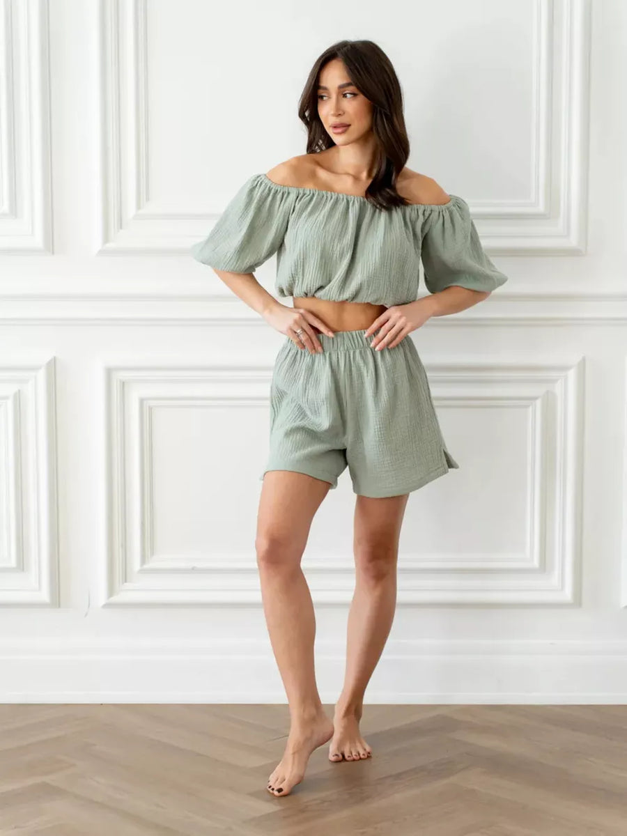 Green cotton off-shoulder cropped top and shorts set with puff sleeves.