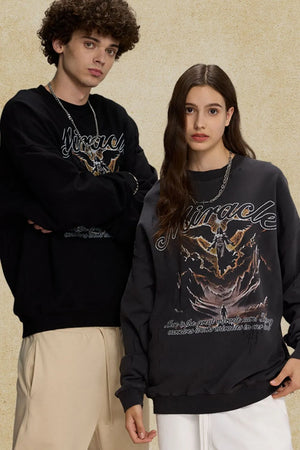 Miracle graphic oversized sweatshirt in black and dark gray with angel and landscape print.