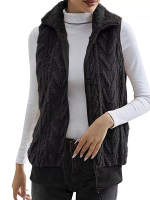 Black faux fur zip-up vest with chevron pattern and ribbed hem