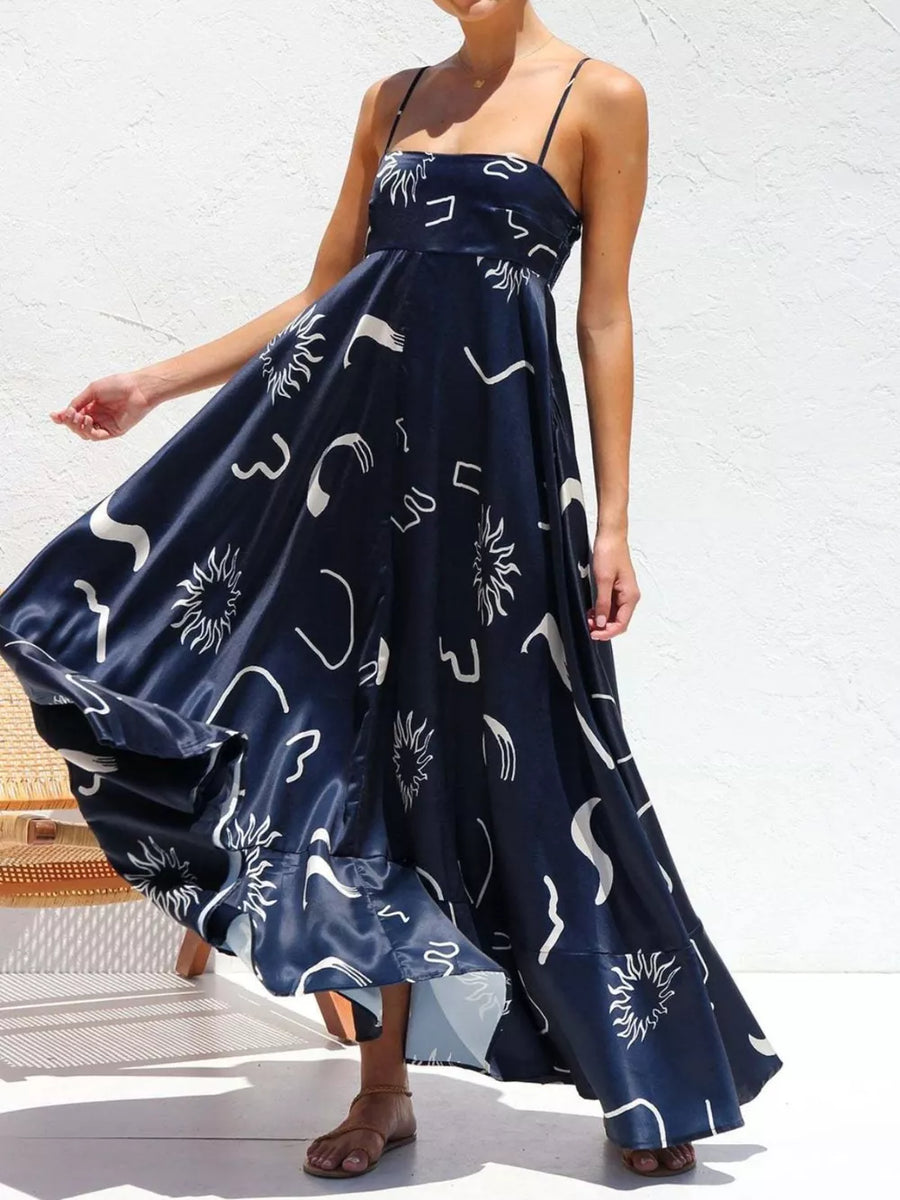 Dark Navy spaghetti strap maxi dress with abstract white print and flowing skirt.