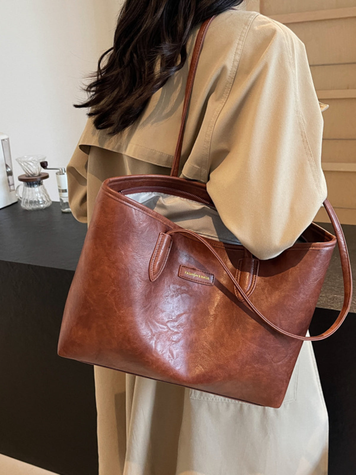 tote in cognac featuring top handle and boxy fit