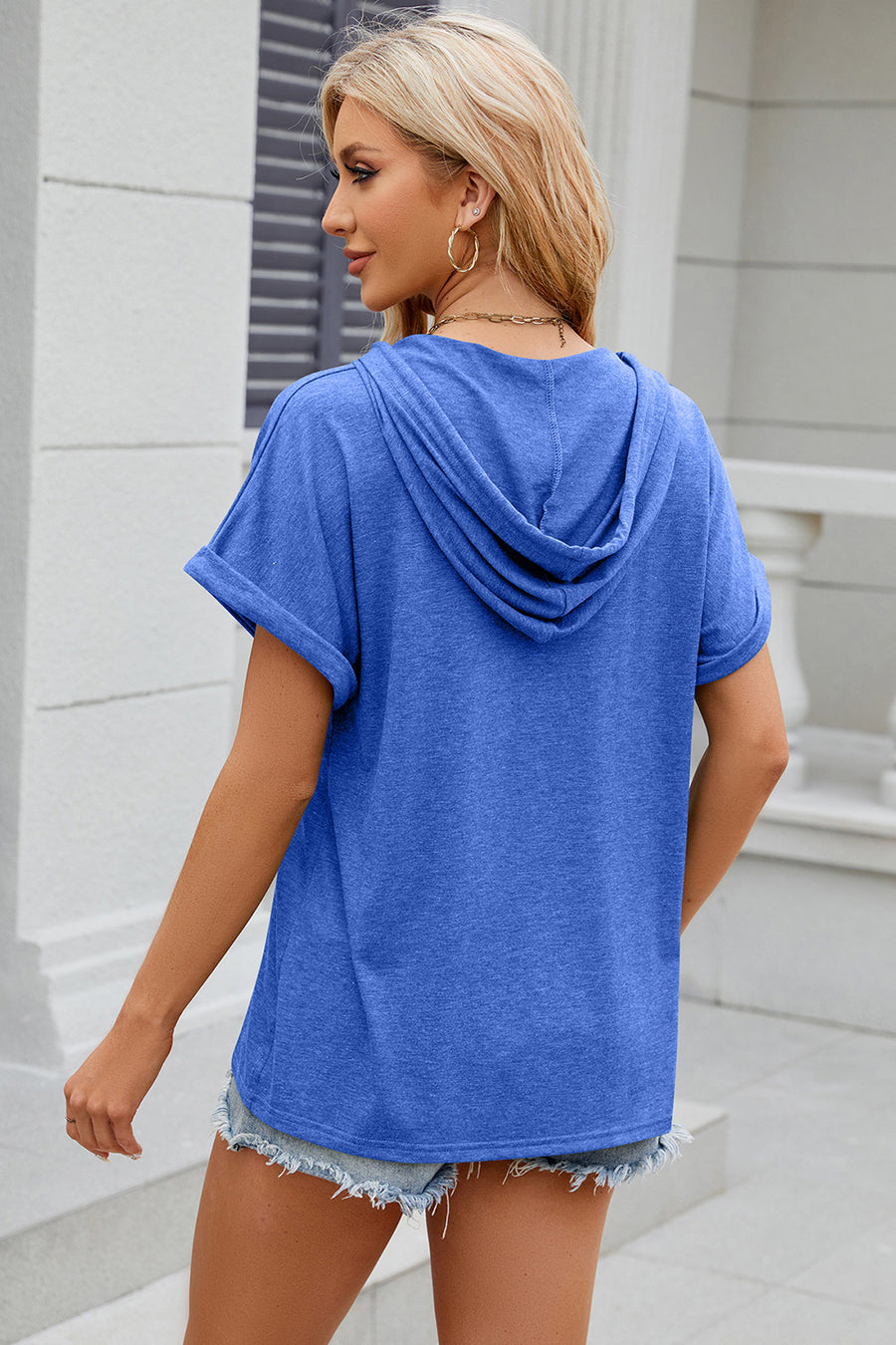Blue hooded t-shirt with rolled short sleeves and a casual fit.