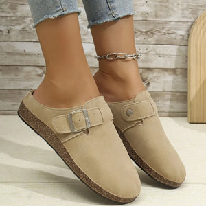 Khaki suede mule flats with buckle detail and cork sole.