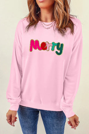 Blush pink crewneck sweatshirt with embroidered colorful "Merry" text and gold trim.