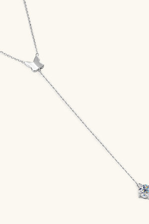 Silver lariat necklace with butterfly charm and moissanite pendant.