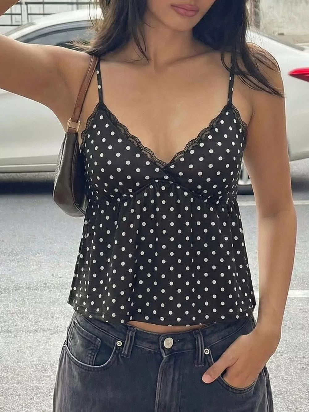Black polka dot cami with lace trim and adjustable straps.