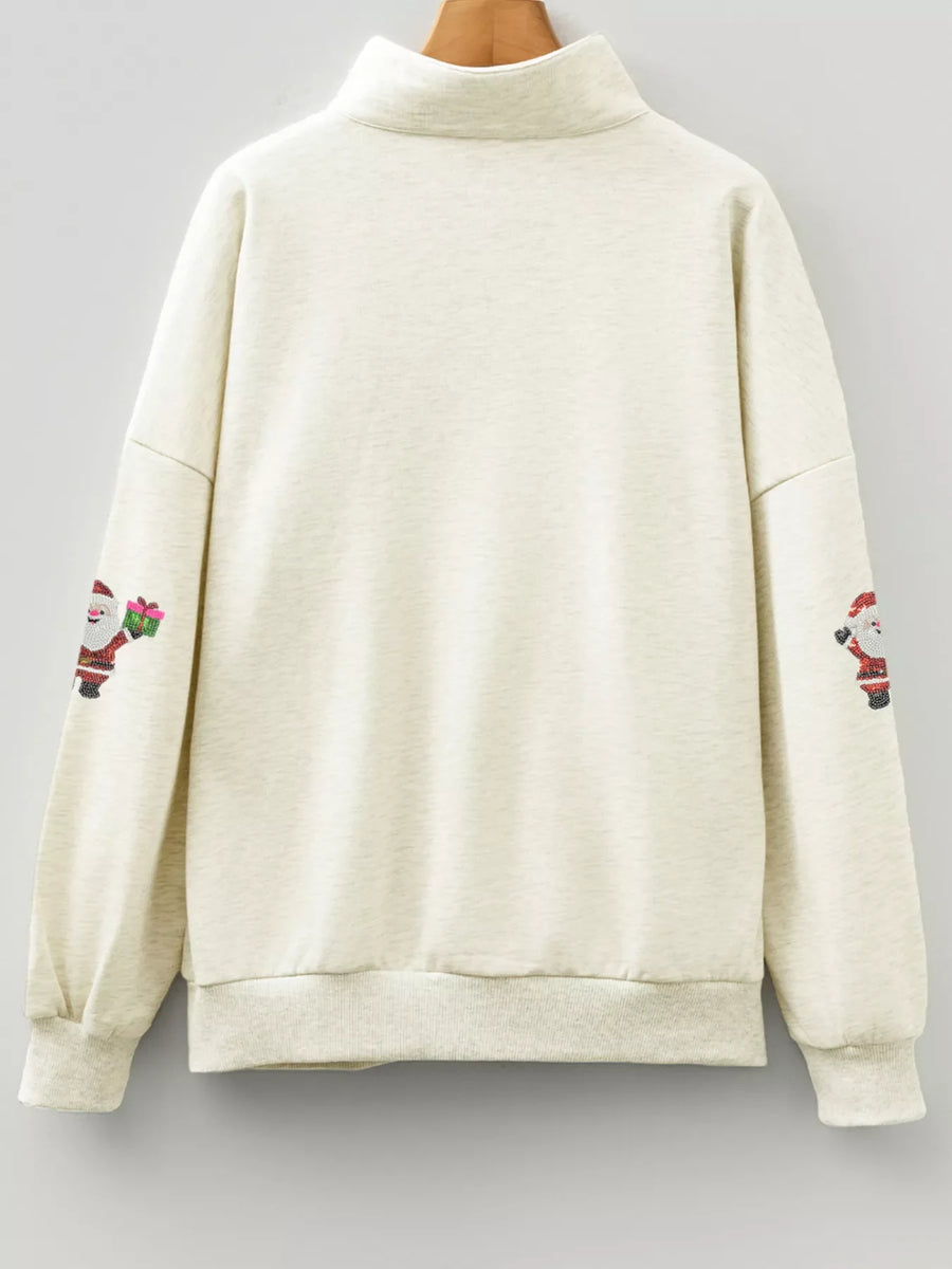 Light gray zip neck sweatshirt with embroidered Santa Claus patches on sleeves.