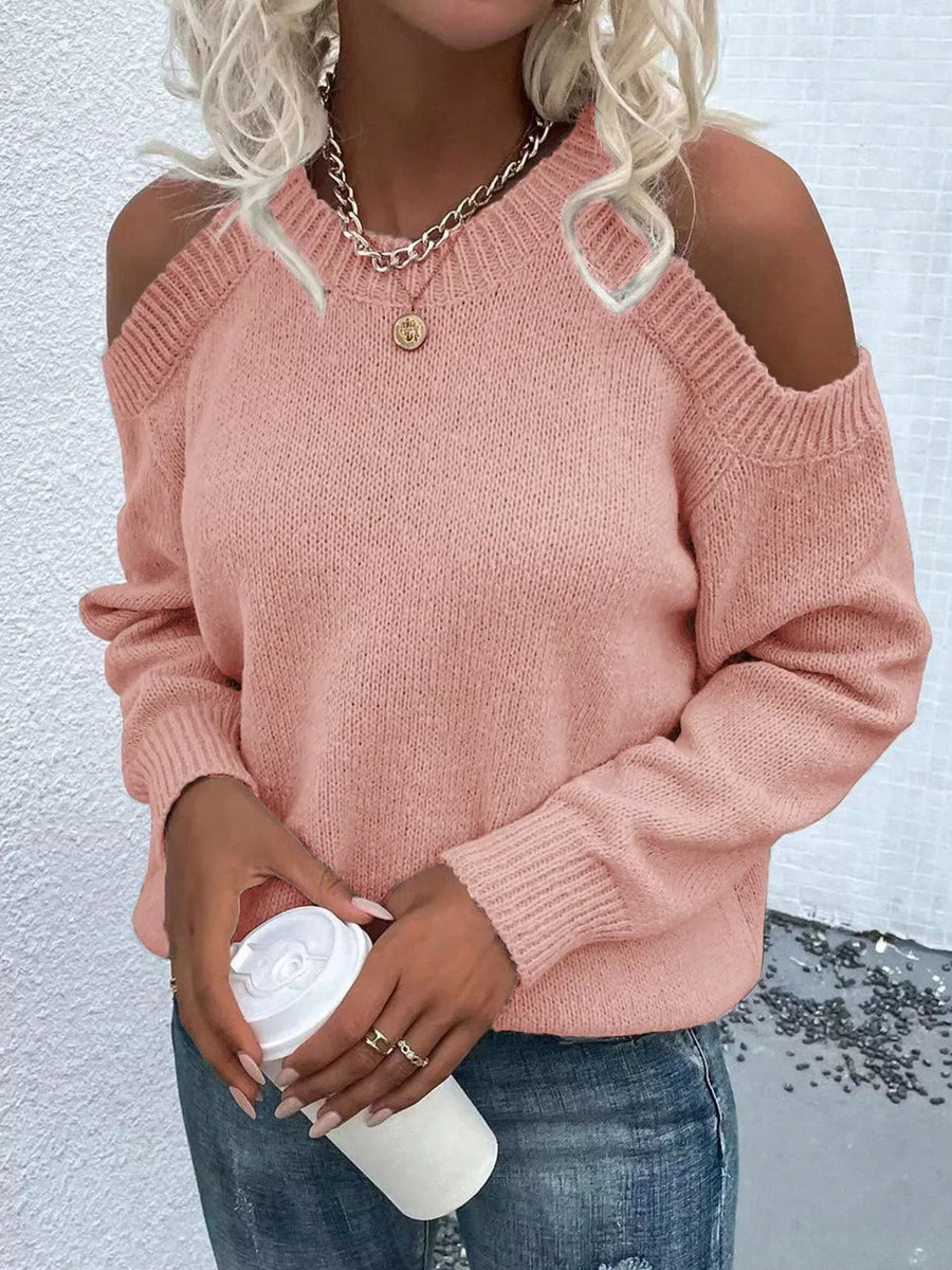 Pink cold shoulder knit sweater with crew neck and long sleeves.