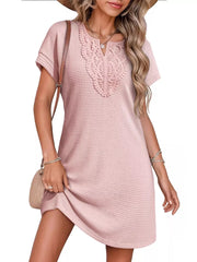 Pink waffle knit dress with lace neckline detail and short sleeves.