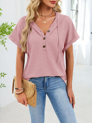 Pink waffle knit short sleeve hooded top with button placket and drawstring hood.