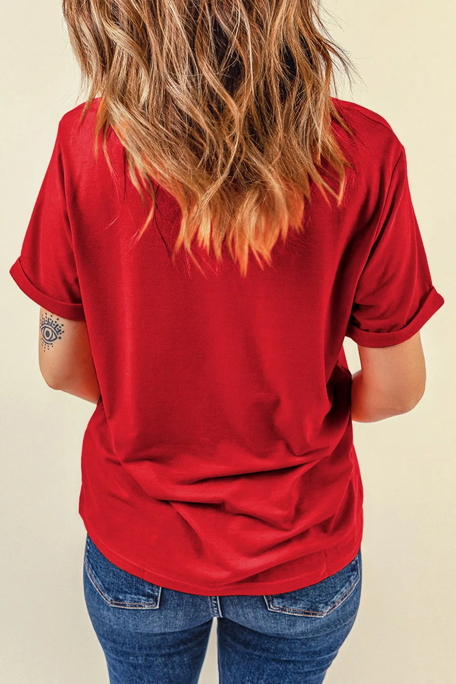 Red graphic tee with cuffed short sleeves and a relaxed fit, styled with blue jeans.
