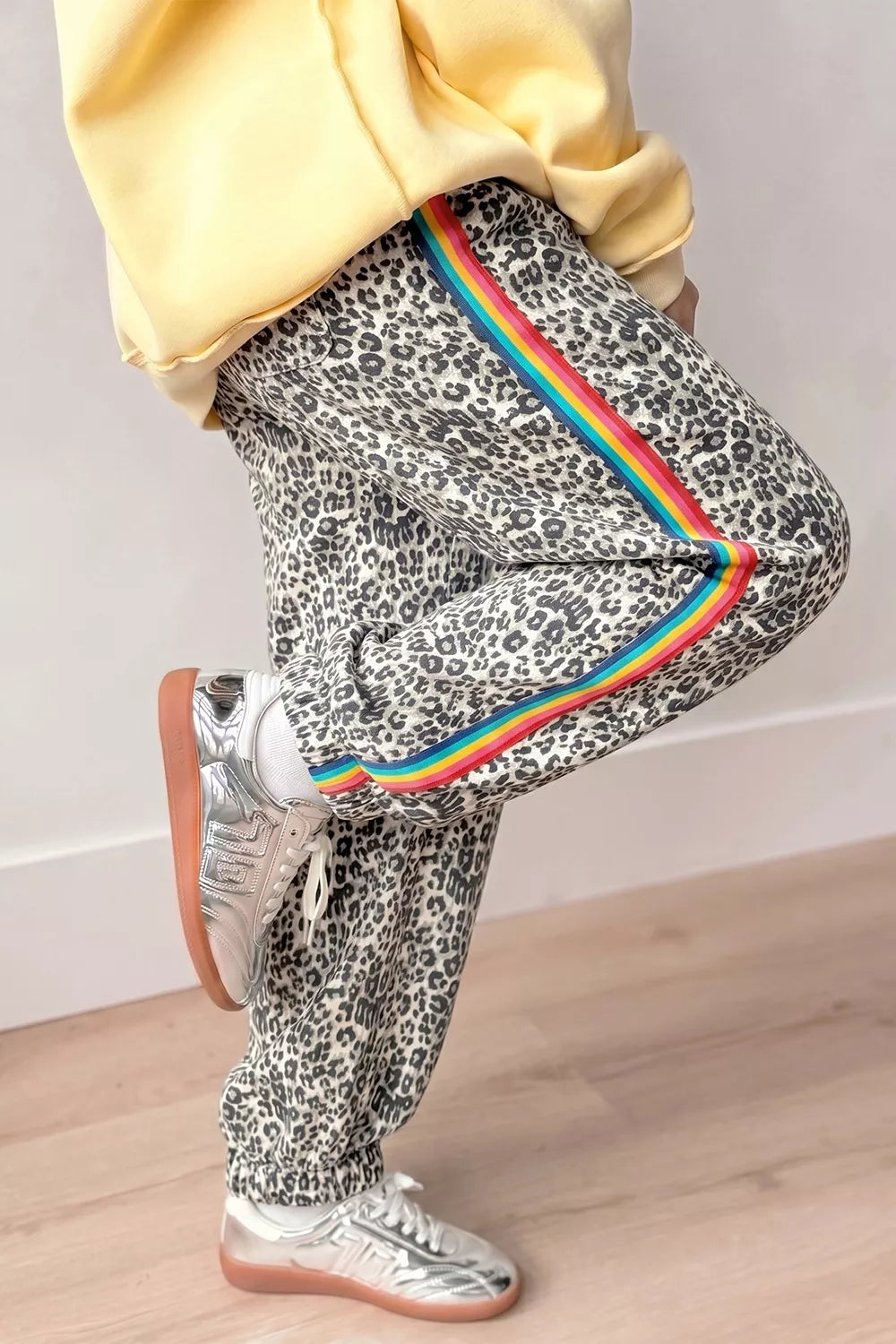 black joggers featuring button-front closure and leopard